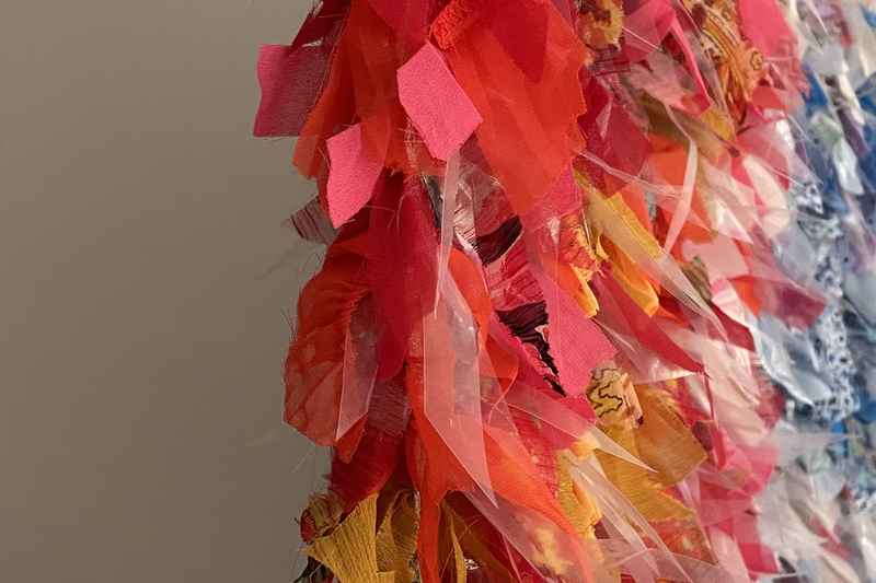 Bilden visar tygremsor i rött, gult och vitt.