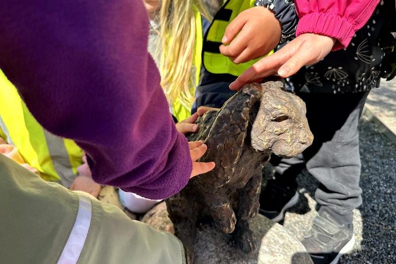 Barnhänder som klappar en bronskanin