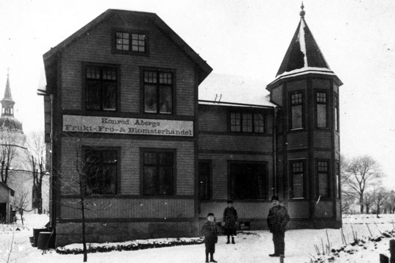 Historisk bild på Brännäsgården, på fasaden sitter skylten Konrad Åbergs Frukt, frö och blomsterhandel.