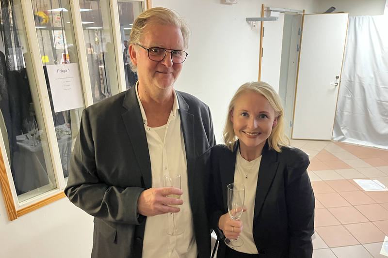 två personer står med bubbelglas i händerna